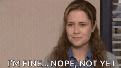 A Woman Is Crying While Covering Her Face With Her Hand . GIF