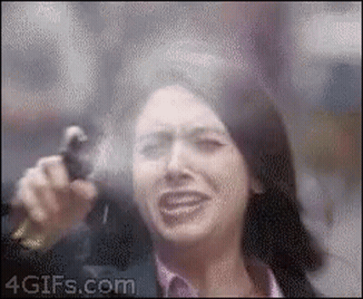 A Woman Is Crying While Holding A Gun In Front Of Her Face GIF