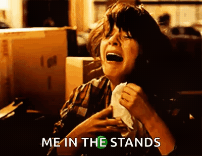 a woman is crying while holding a napkin in her hand and saying `` me in the stands '' .