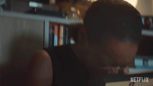 A Woman Is Crying While Holding A Picture Frame With A Netflix Logo On It GIF