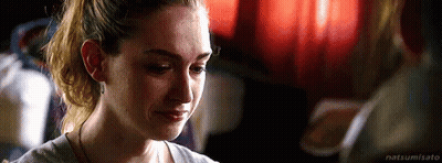 A Woman Is Crying While Looking At Another Woman . GIF