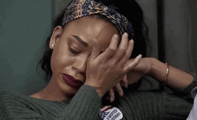 A Woman Is Crying While Wearing A Sweater That Says I Voted Today On It . GIF
