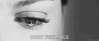 A Woman Is Crying With A Tear Coming Out Of Her Eye In A Black And White Photo . GIF