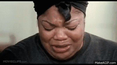 A Woman Is Crying With Her Eyes Closed And Wearing A Black Headband . GIF