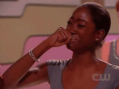 A Woman Is Crying With Her Fist In Her Mouth . GIF