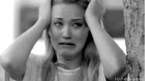 A Woman Is Crying With Her Hands On Her Head . GIF