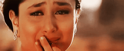 A Woman Is Crying With Tears Coming Out Of Her Eyes . GIF