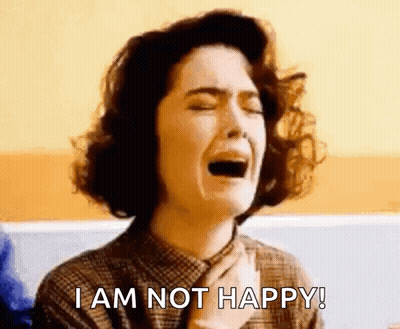 A Woman Is Crying With The Words `` I Am Not Happy '' Written Below Her . GIF