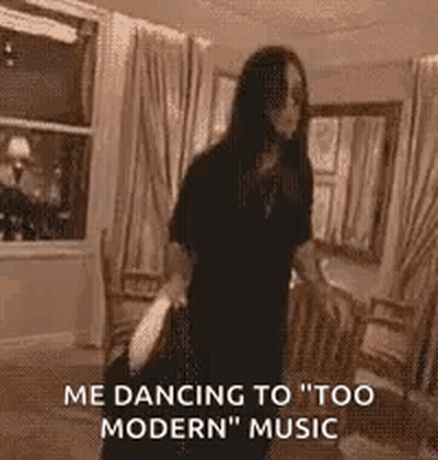 A Woman Is Dancing In A Living Room While Holding A Bag . GIF