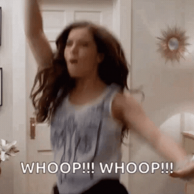 A Woman Is Dancing In A Room With Her Arms In The Air And Says Whoop ! Whoop ! Whoop ! GIF