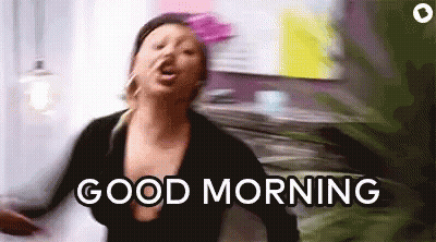 A Woman Is Dancing In A Room With The Words `` Good Morning '' Written On The Screen . GIF