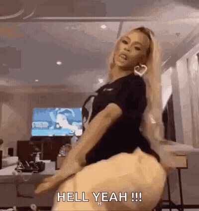 A Woman Is Dancing In A Room With The Words `` Hell Yeah !!! '' Written On The Bottom Of The Image . GIF