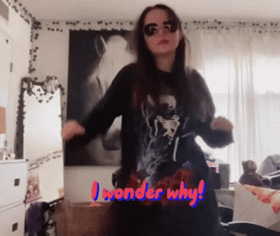 A Woman Is Dancing In A Room With The Words " I Wonder Why " Written On The Bottom GIF