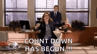 A Woman Is Dancing In An Office While A Man Stands Behind Her And Says `` Count Down Has Begun ! '' GIF