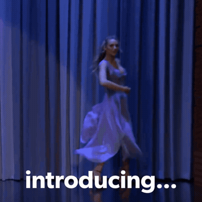 A Woman Is Dancing In Front Of A Blue Curtain With The Words Introducing GIF