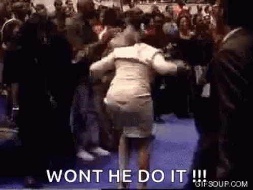 A Woman Is Dancing In Front Of A Crowd With The Words `` Won 'T He Do It '' . GIF
