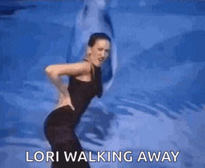 A Woman Is Dancing In Front Of A Dolphin And The Words `` Lori Walking Away '' . GIF