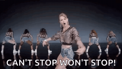 A Woman Is Dancing In Front Of A Group Of Dancers . GIF