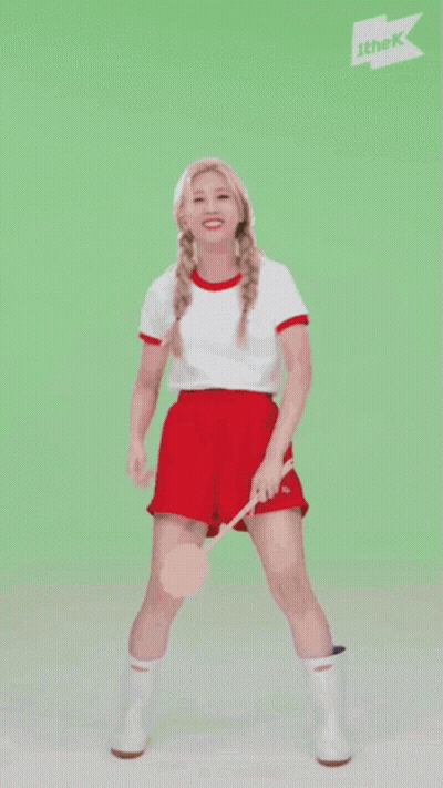 A Woman Is Dancing In Front Of A Sign That Says ' Ithek ' On It GIF