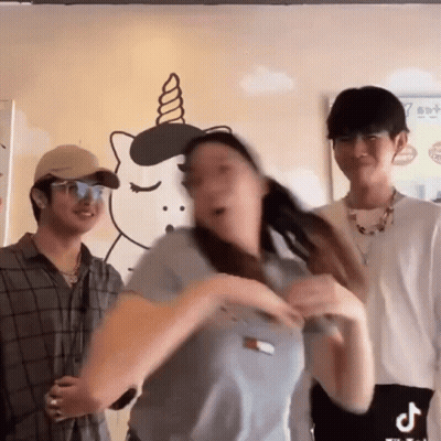 A Woman Is Dancing In Front Of A Wall With A Unicorn Drawing On It GIF