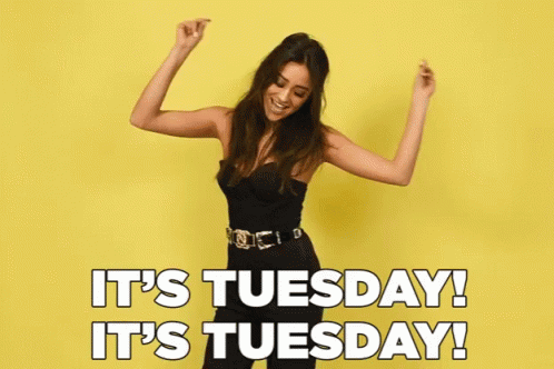 A Woman Is Dancing In Front Of A Yellow Background With The Words It 'S Tuesday GIF