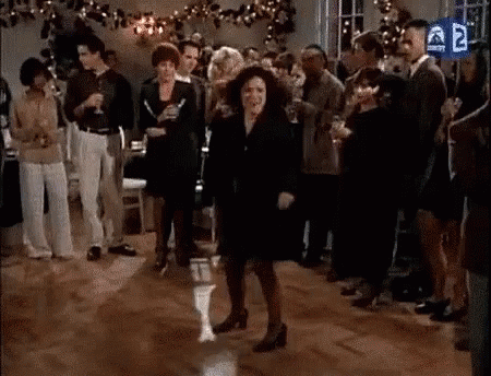 A Woman Is Dancing On A Dance Floor At A Party While A Crowd Watches . GIF