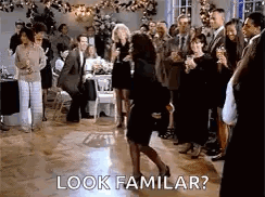 A Woman Is Dancing On A Dance Floor At A Party While A Group Of People Watch . GIF