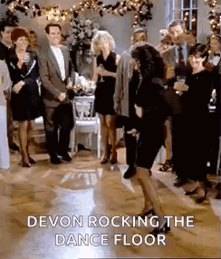 A Woman Is Dancing On A Dance Floor At A Party While A Group Of People Watch . GIF
