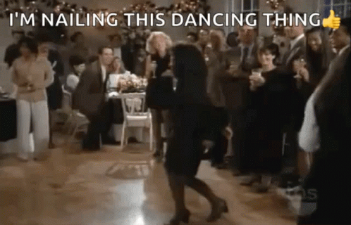 A Woman Is Dancing On A Dance Floor In Front Of A Crowd At A Party . GIF