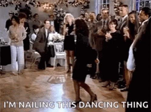 A Woman Is Dancing On A Dance Floor In Front Of A Crowd Of People At A Party . GIF