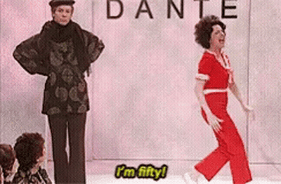 A Woman Is Dancing On A Stage In Front Of A Sign That Says Dante GIF