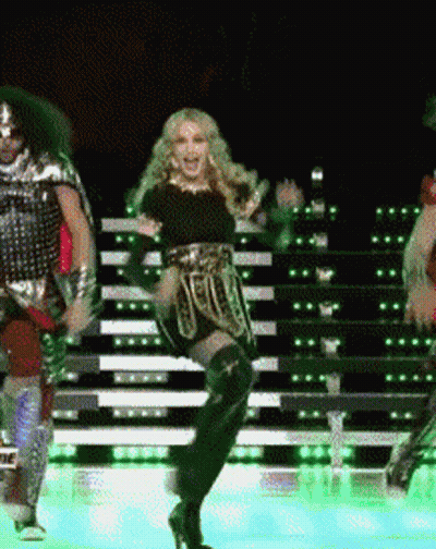 A Woman Is Dancing On A Stage With A Man In Armor GIF