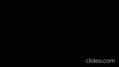 A Woman Is Dancing On A Stage With A Microphone . GIF