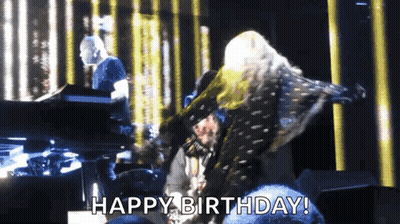 A Woman Is Dancing On A Stage With The Words Happy Birthday Written Below Her GIF