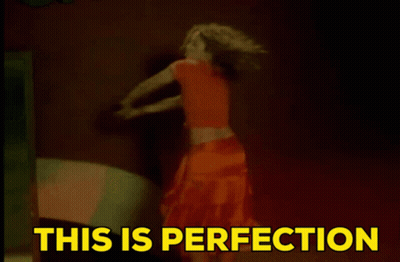 A Woman Is Dancing With The Words " This Is Perfection " Above Her GIF