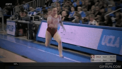 A Woman Is Doing A Trick On A Trampoline In Front Of A Sign That Says Oklahoma GIF