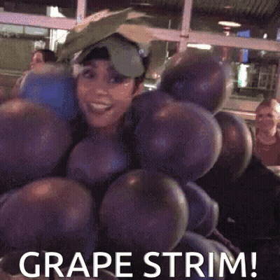 A Woman Is Dressed As A Bunch Of Grapes And Says Grape Trim GIF