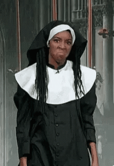 A Woman Is Dressed As A Nun And Making A Face . GIF
