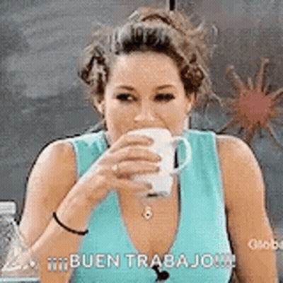 A Woman Is Drinking A Cup Of Coffee While Wearing A Blue Shirt . GIF