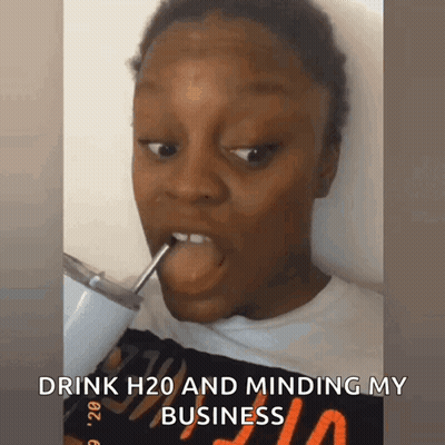 A Woman Is Drinking H2o Through A Straw And Minding Her Business GIF