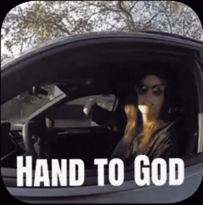 A Woman Is Driving A Car With The Words Hand To God Written On The Window GIF