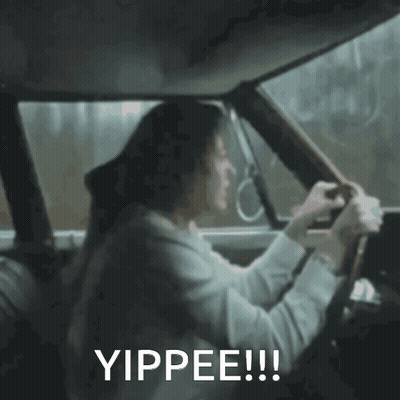 A Woman Is Driving A Car With The Words Yippee Written On The Bottom GIF