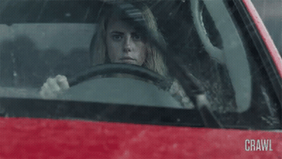 A Woman Is Driving A Red Car And The Word Crawl Is On The Windshield GIF