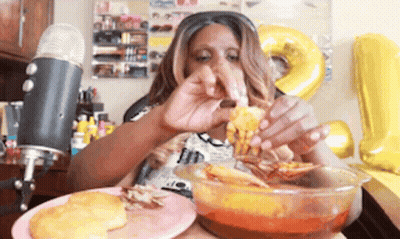 A Woman Is Eating A Bowl Of Food In Front Of A Microphone GIF