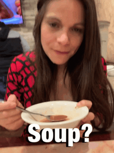 A Woman Is Eating A Bowl Of Soup With The Words Soup Written Below Her GIF