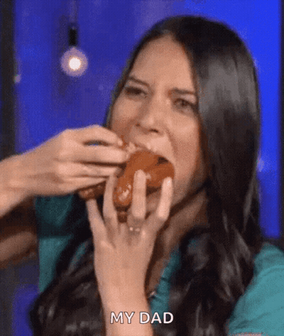 A Woman Is Eating A Donut With Her Hands And Says My Dad . GIF