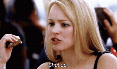 A Woman Is Eating A Piece Of Pizza And Says Shut Up . GIF