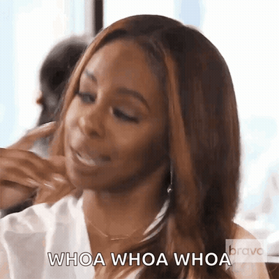 A Woman Is Eating A Sandwich And Says Whoa Whoa Whoa . GIF