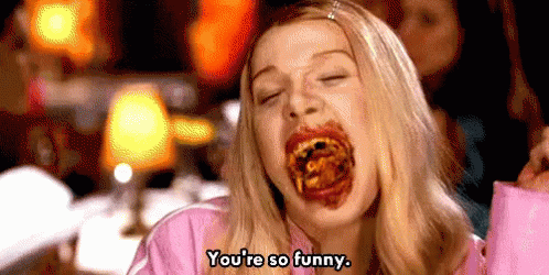 A Woman Is Eating Food And Making A Funny Face . GIF