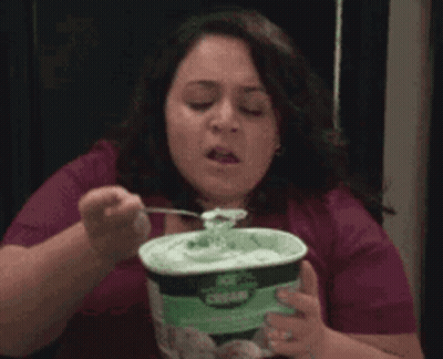 A Woman Is Eating Ice Cream With A Fork GIF